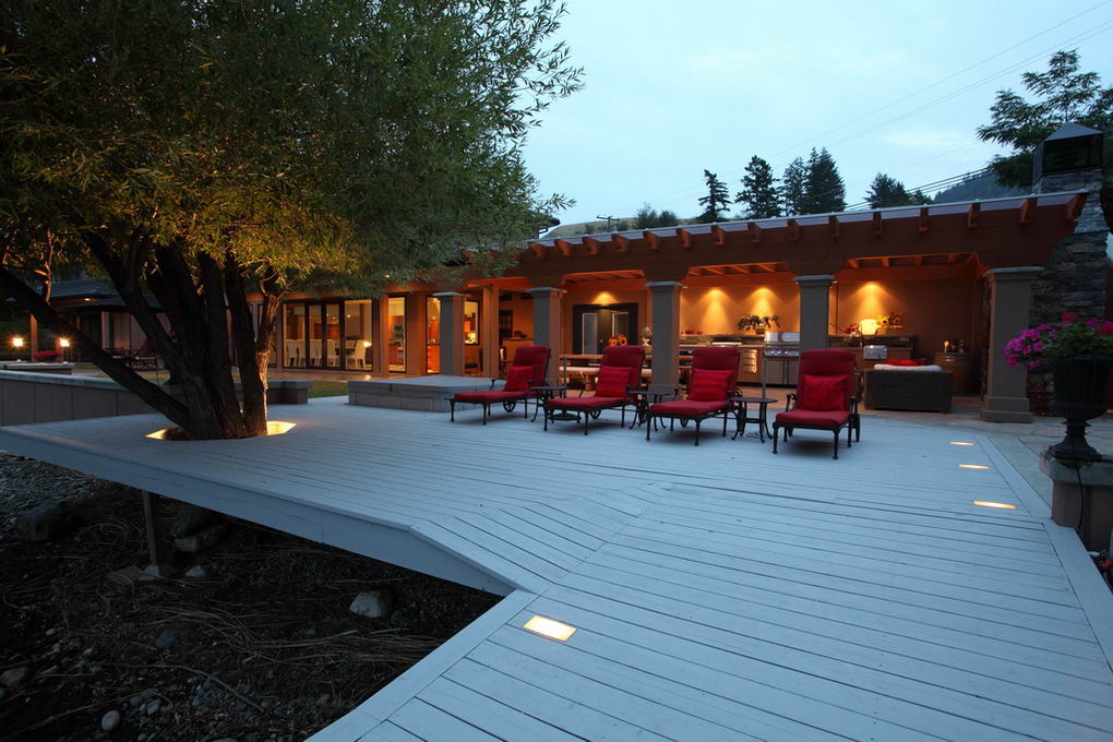 Wide view of a lakeside outdoor kitchen and covered patio in Vernon British Columbia