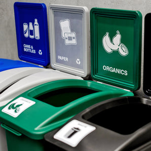 Three recycling bins with labeled lids for cans & bottles, paper, and organics.